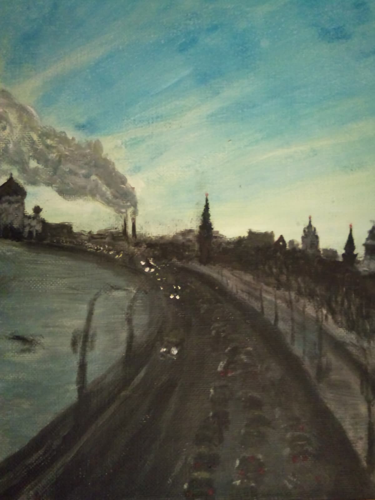 Vertical view of the same cityscape, traffic curving along the embankment