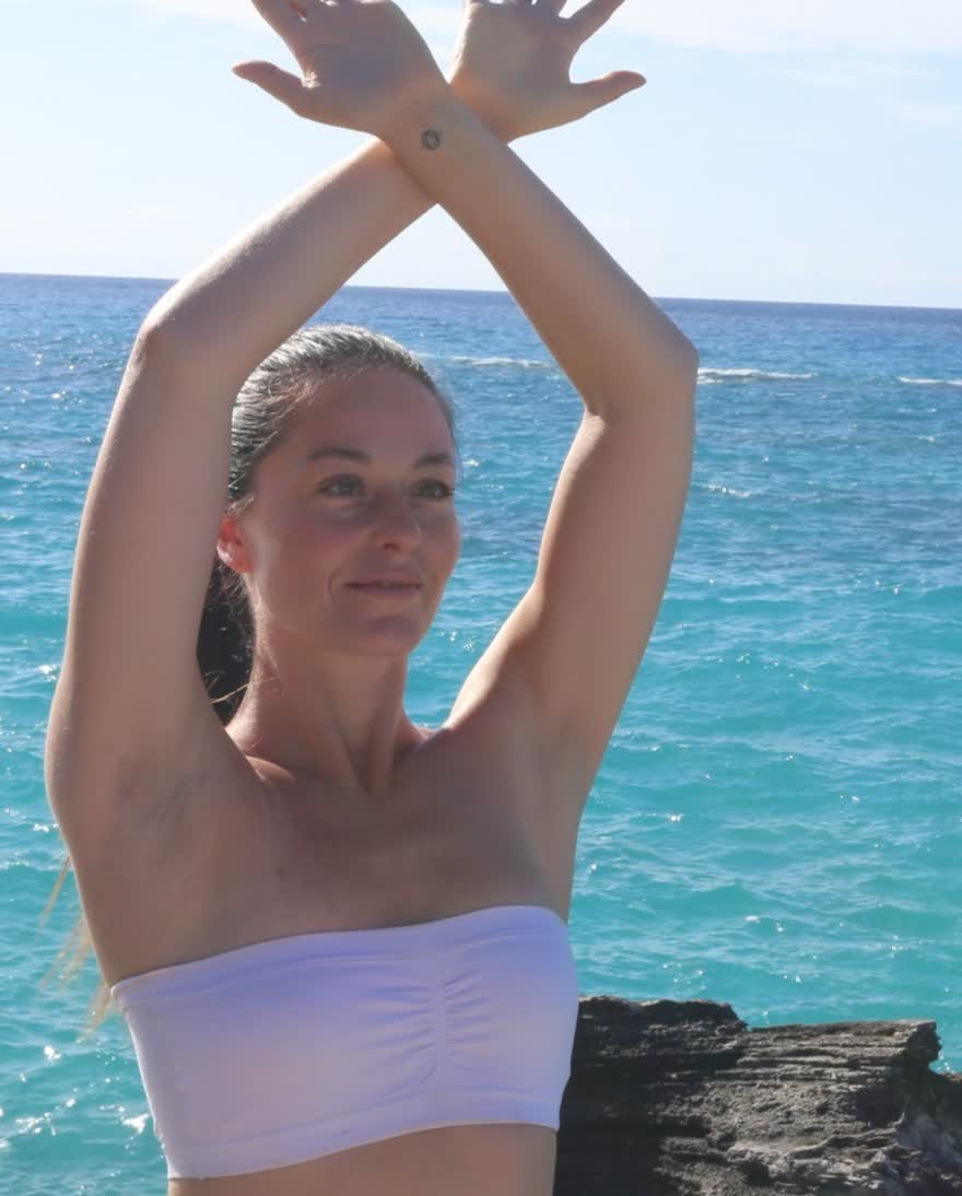 Reya Mithra with her palms open to the sky