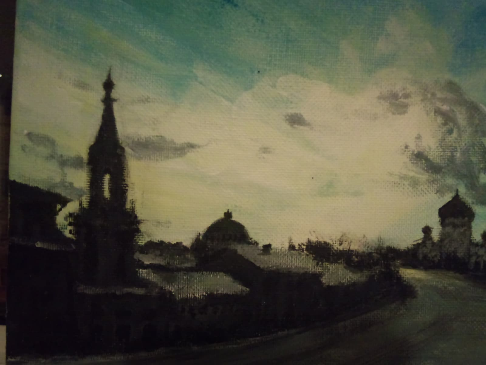 Detail of the cityscape — spire and dome silhouettes against a turquoise sky